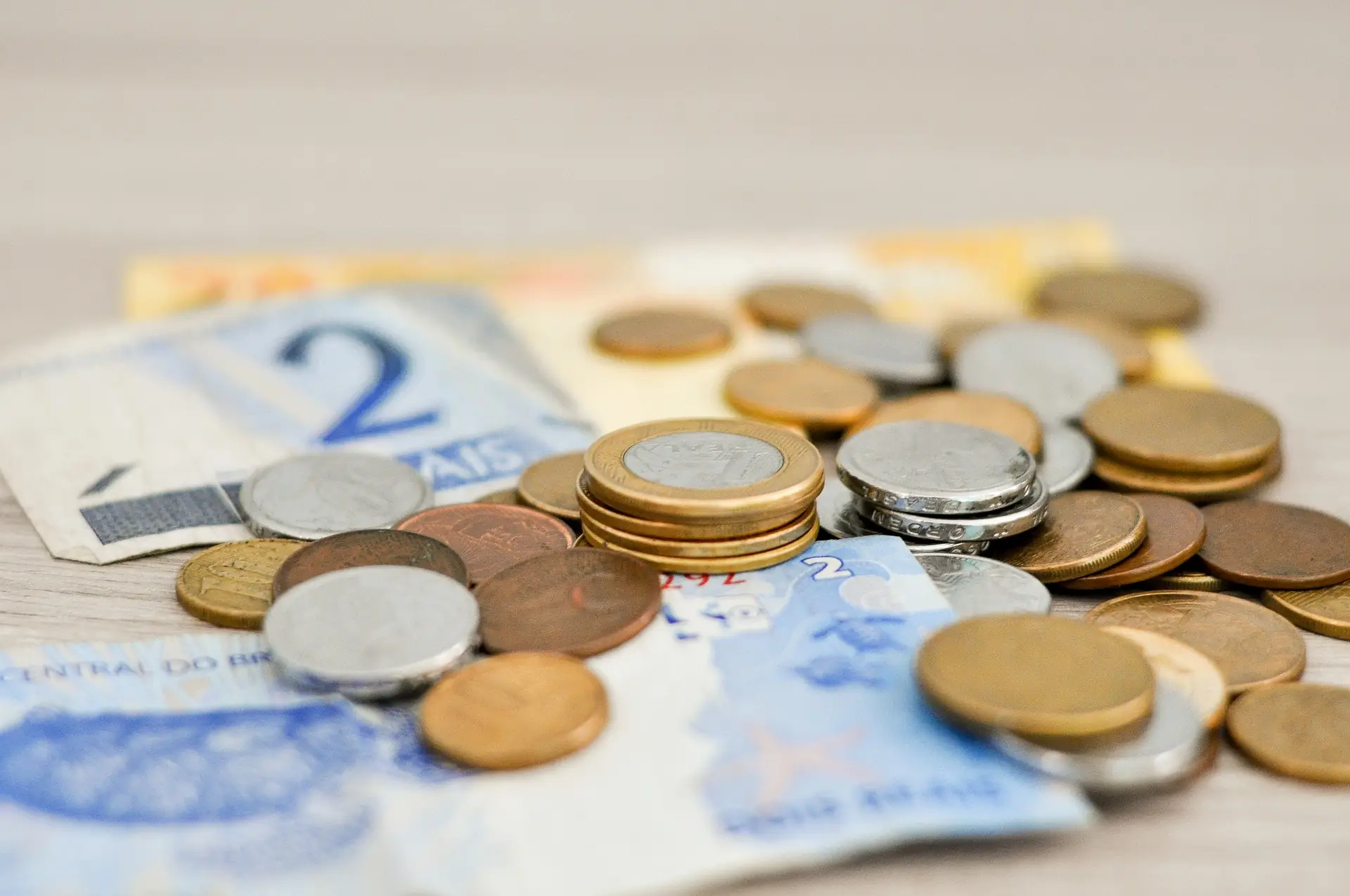 Bank notes and coins spread on a table
