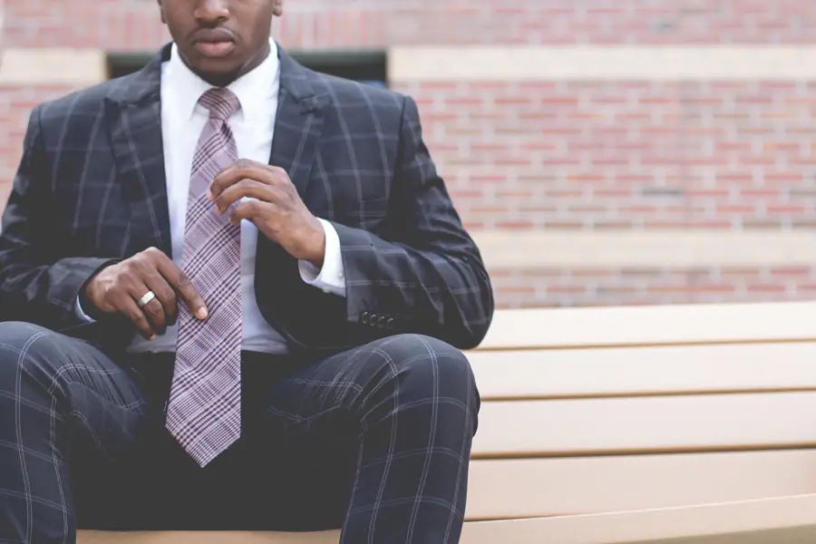 Business owner in a suit seated on a bench