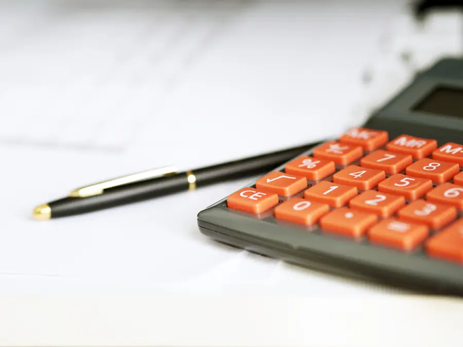 Pen resting beside a calculator on paperwork